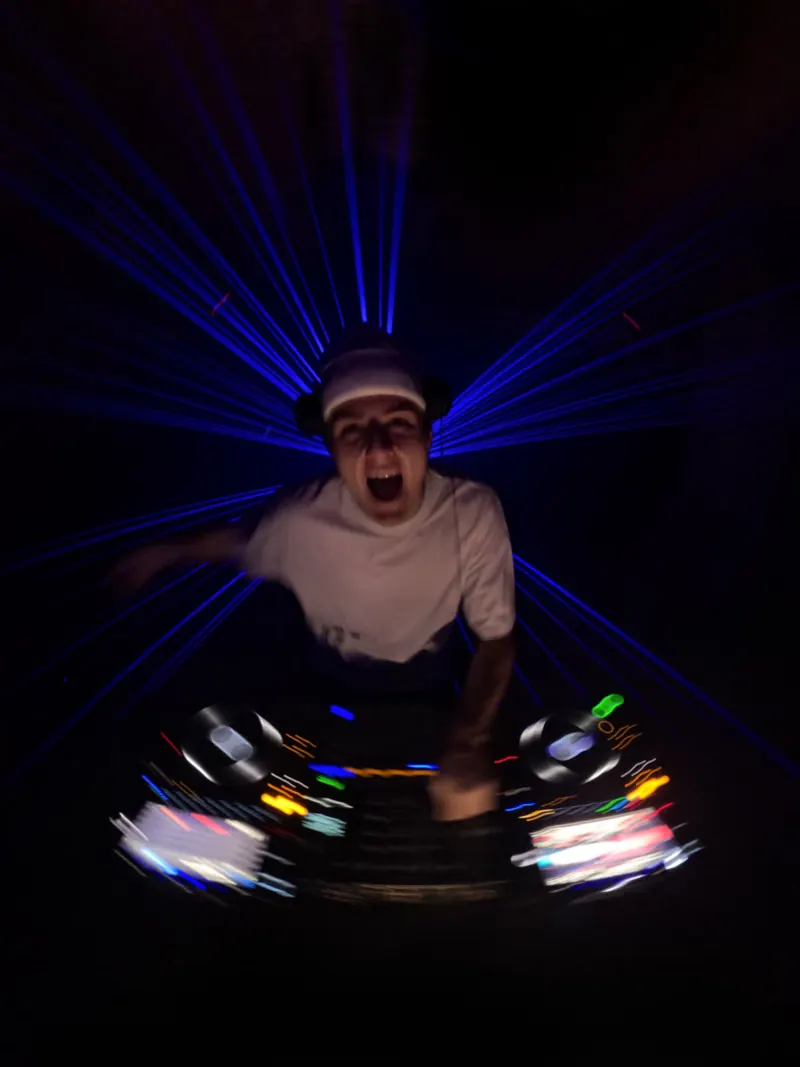 MĀT behind the decks under lasers