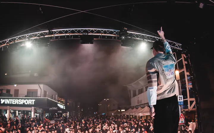 MĀT on stage in front of a full crowd